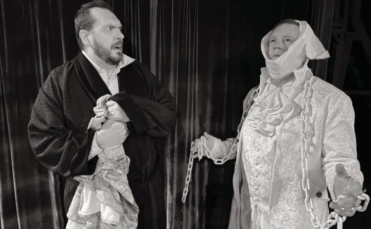 Scott Bartley (Ebinezer Scrooge) is frightened when he is visited by Robert Benton (a ghost of Christmas) in Shawnee Little Theatre’s production of “A Christmas Carol.” Photo provided by SLT