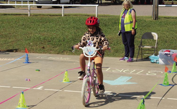 Evie Satterwhite, 7, of Shawnee, begins the bicycle rodeo course, presented by Pottawatomie Go during Pedalpalooza, which was held at Rotary Briscoe Boy Scout Park on Sept. 20. In addition to the bike rodeo, there were several booths, including Epic Snocones, First United Bank, VIPS, Kids Action, Pioneer Library Systems - Shawnee Library, OBU, Willier USA, Salty Dogs Cycling, Mabee-Gerrer Museum of Art, and LOL Cartoons Party Entertainment. Natasha Dunagan, Countywide & Sun