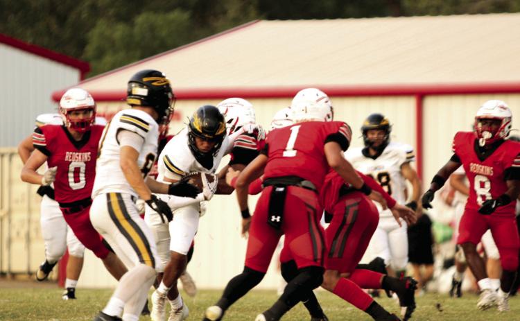 Tecumseh senior Jekhi Owens sidesteps the McLoud defense after catching a pass from junior Wyatt Dodgion during the game at McLoud on Sept. 19. The Tecumseh Savages won, 33-26. Natasha Dunagan, Countywide &amp; Sun