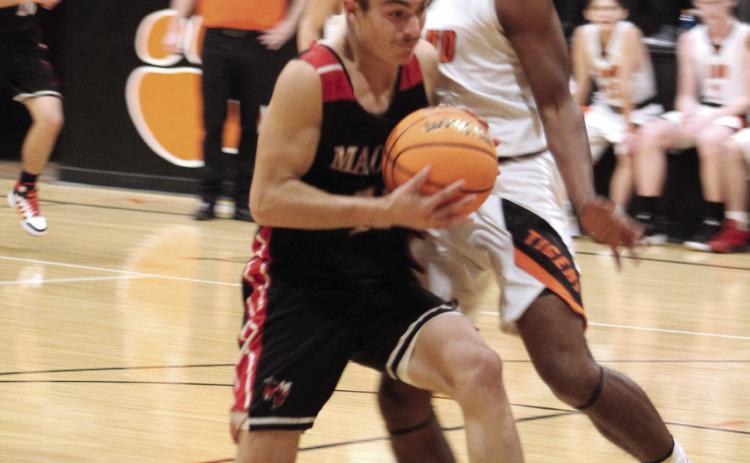 Macomb’s Cameron Richardson prepares to shoot for two, as Maud’s Vcake Wassana-Street plays defense during the second half of the Maud home game on Nov. 29. The Maud Tigers won 78-36, and the Lady Tigers won, as well, 56-26.