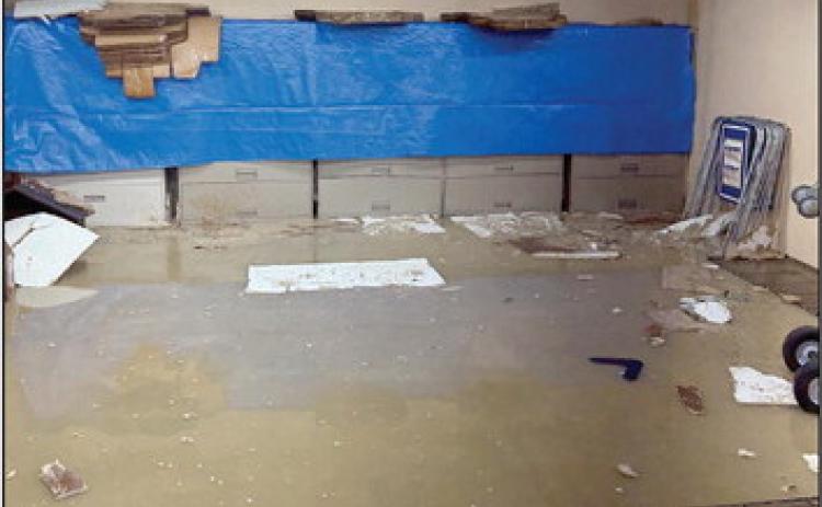 Staff works quickly to get records out of the flooded basement. Approximatey 3-5 inches of water filled the entire basement on Tuesday.