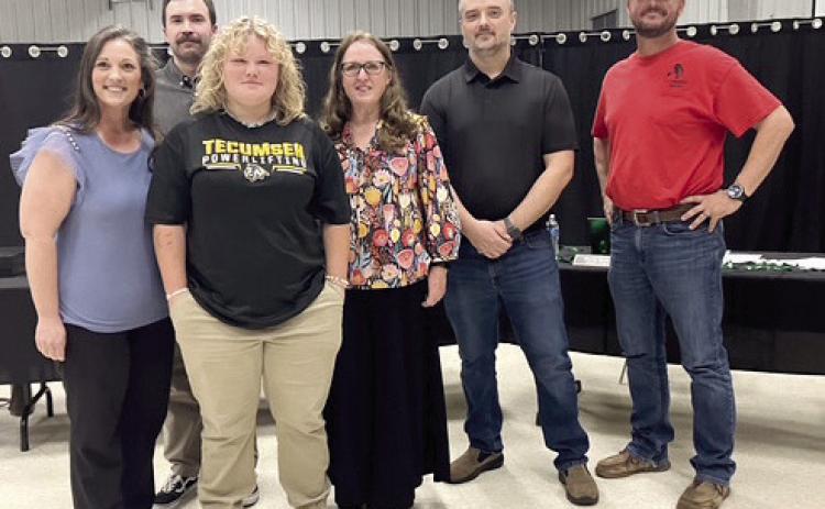 Eighth grader, Jaydi Peacock, poses with the Tecumseh School Board as they recognize her as a State Powerlifting Champion for Tecumseh Middle School. Adelaide Lack, Intern, Countywide & Sun