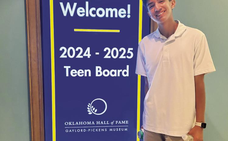 Shawnee High School senior Ahlijah Gipp stands by a sign welcoming the Oklahoma Hall of Fame Teen Board members from across the state. Gipp was the only student from Pottawatomie County to be chosen for the board. Photo provided.