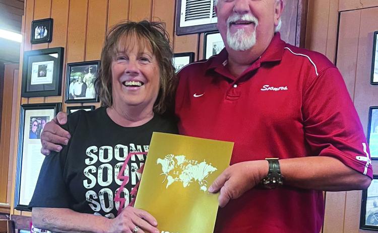Oklahoma Junior Chamber International Senate President Randy Sursa presents Kimberly Rawls with a certificate, lapel pen and name badge, as he declares her to be a JCI Senator, during a meeting held at Van's Pig Stand in Shawnee on Aug. 23. Photo provided
