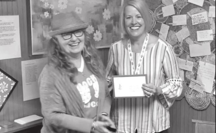 Retired RSU English professor Roxann Yates presents the first-place award in the Oklahoma Poetry Contest to Tecumseh fifth-grade teacher Cody Swinson on April 16. Photo provided.