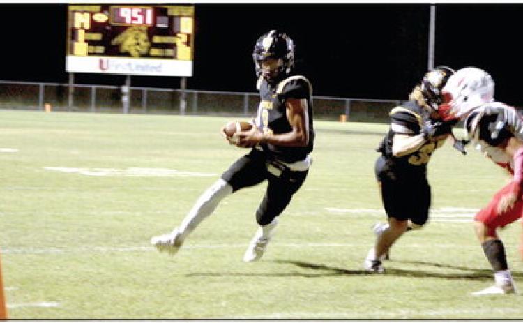 Tecumseh junior Marquan Krush runs the ball - as Conner Barksdale keeps a McLoud player at bay - for a touchdown in the second quarter of the Homecoming game on Sept. 16. The Tecumseh Savages won 40-14. Countywide &amp; Sun/Natasha Dunagan