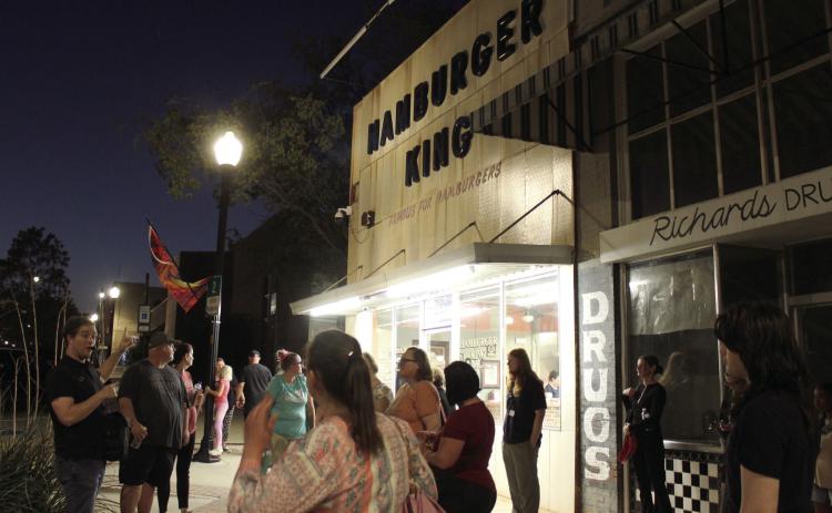 Oklahoma City Community College English Professor Jeff Provine leads the Haunted Downtown Shawnee tour for about 25 people on Oct. 11. Provine said Hamburger King is said to be haunted by its founder, Joseph Macsas, as well as its former owners who can be heard moving furntiture upstairs, since it was a furniture store. The Community Matters event was hosted by the Shawnee Public Library. Provine is also the author of "Haunted Shawnee OK," and he held a book signing at The Arts at 317 earlier that day.