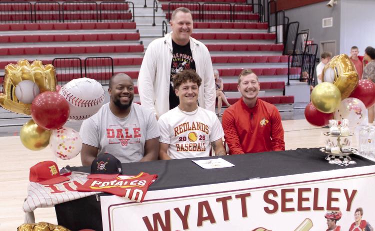 Dale senior Wyatt Seeley poses with Dale Head Boys Basketball Coach Fletcher Reed, right, and Assistant Coaches Oliver Willis, left, and Josh Forsythe. Seeley played both basketball and baseball and will continue his baseball career with Redlands Community College in El Reno.