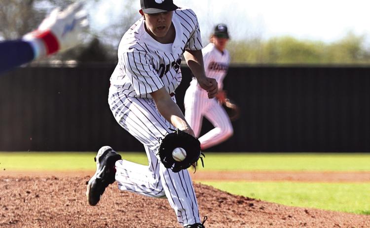 North Rock Creek’s Jace Plumb gets the ball hit back to him and makes the throw to first for the out.