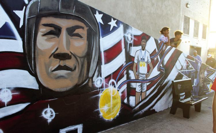 A mural honoring Jim Thorpe was painted by Nicholas Blanchard along the ramp to the bleachers at Jim Thorpe Stadium, and a ribbon-cutting ceremony was held as part of Shawnee Public Schools Jim Thorpe Night before the home football game on Sept. 27. Countywide & Sun/Natasha Dunagan