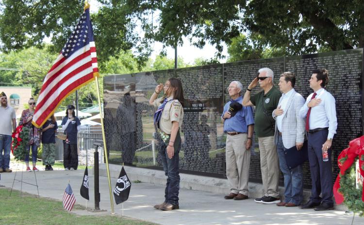 Troop 477 Eagle Scout Lucas Schafer, 16, salutes the U.S. flag after posting the colors, as veterans Bill Ford and Jerry Shiles, State Senator Shane Jett and former State Rep. Justin Wood and others do the same, during the Shawnee Memorial Day ceremony at Woodland Veterans Park on May 25. Jett and Wood spoke at the event. Photos by Natasha Dunagan, Countywide & Sun