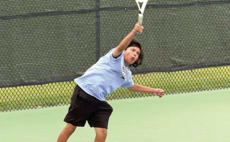 Tecumseh freshman Noah Mason serves in #2 Doubles at the Elk City Tennis Tournament on April 22. Along with doubles partner Jaxon McCullough, Mason placed sixth. The #1 Doubles team of Xzavier Kommer and Eli Mullins took seventh. Both Ted Belshe, in #1 Singles, and Christian Falcon, in #2 Singles, earned fifth place. The Savages tennis team also placed fifth. Photo courtesy of Jennifer McKnight