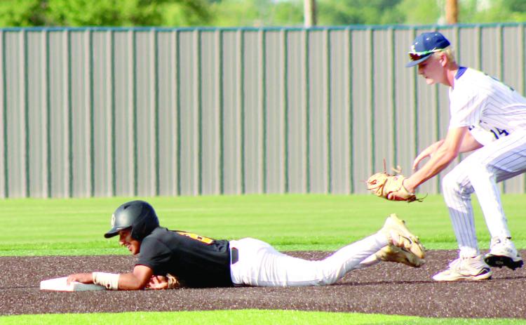 Shawnee sophomore Ty Janda tries to tag a runner who dove back to second base in the May 5 home game with Santa Fe South.