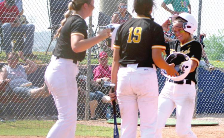 Tecumseh senior Lauren Taylor taps helmets with her teammates after she hit a home run in the third inning of the Class 5A State Tournament Quarterfinal game against Stilwell, held at the USA Softball Hall of Fame on May 9. The Lady Savages slow-pitch softball team won, 14-8, but they fell in the Semifinals, 1-5, to Perkins-Tryon that same day. They end their season with a record of 29-8. Countywide &amp; Sun/ Natasha Dunagan