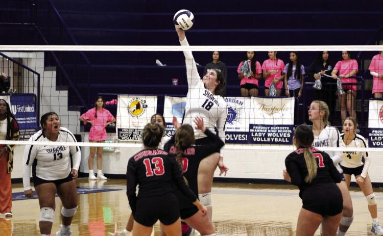 Shawnee’s Dalaney Vranga (#18) returns the ball over the net, as teammate Kanynn Kaseca (#13) cheers her on, during the home match against North Rock Creek on Sept. 19. The NRC Cougars won 3-0 (2518, 25-13, 25-10). Countywide &amp; Sun/ Natasha Dunagan