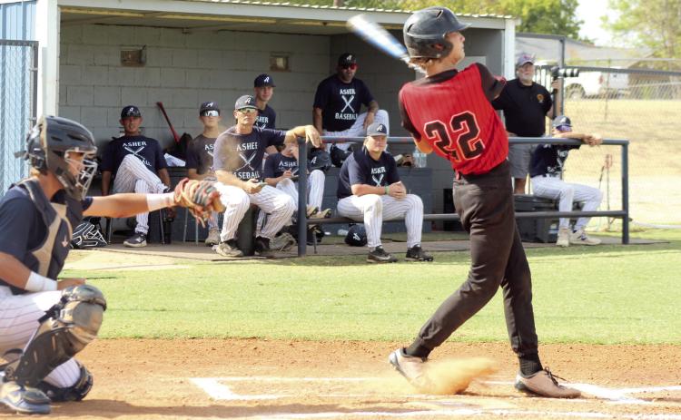 Macomb freshman Asher Schooler takes a swing, as Asher senior Hunter Francis makes the catch during the Class B District Tournament game at Asher on Sept. 23. The Indians won 23-0. They also won both their games against Whitesboro on Sept. 23, 19-4, and on Sept. 24, 14-6. Natasha Dunagan, Countywide &amp; Sun