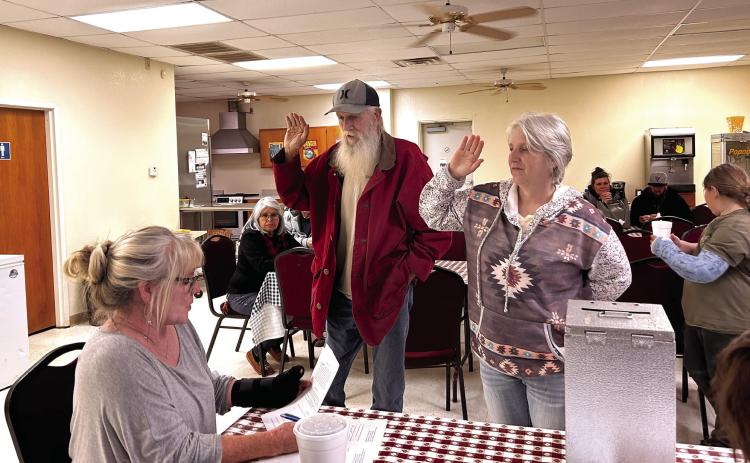 Pottawatomie County Clerk Raeshelle Flewallen swears Macomb Trustee 1 David Griffith and Trustee 2 Tami Perez into office. Perez won the coin toss for the position of Mayor. Countywide & Sun/Suzie Campbell
