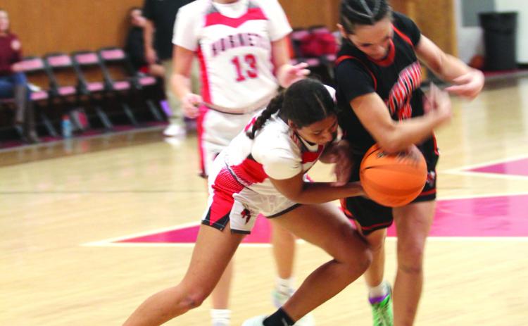McKenzie Brummett tries to steal the ball during the second quarter of the Jan. 16 home game against Strother. The Lady Hornets won 67-64 in overtime. Later, the Hornets lost 47-59.