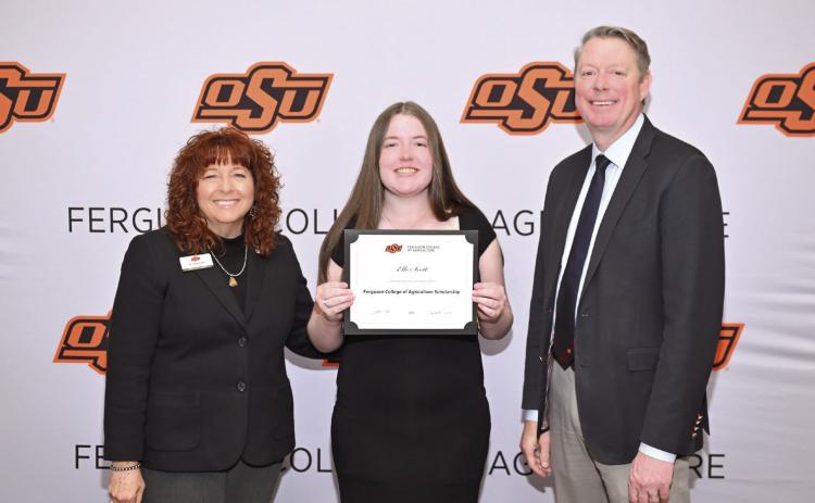 Cynda Clary, associate dean for academic programs and Jayson Lusk, dean for the Ferguson College of Agriculture, present Elle Scott with a scholarship Photo provided by OSU