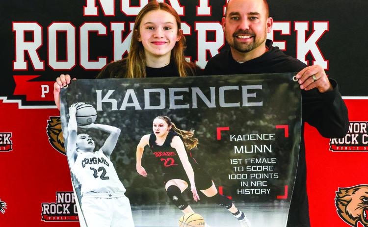 On Jan. 21st at the Washington tournament, Kadence Munn scored her 1000 point in her high school career against Tecumseh. Pictured are Kadence Munn and NRC Basketball Coach Lance Blocker.