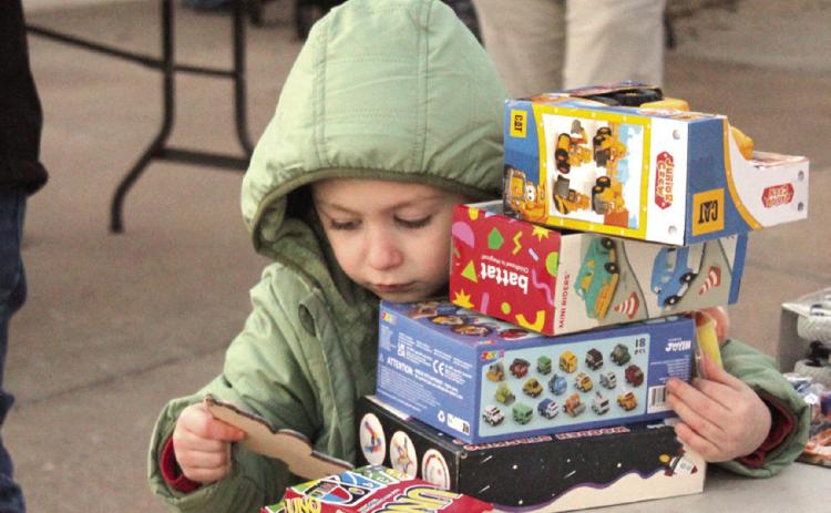 Greyson Diaz, 5, found a stack of gifts during the Fourth Annual Shawnee Police Department Toy Drive on Dec. 18.