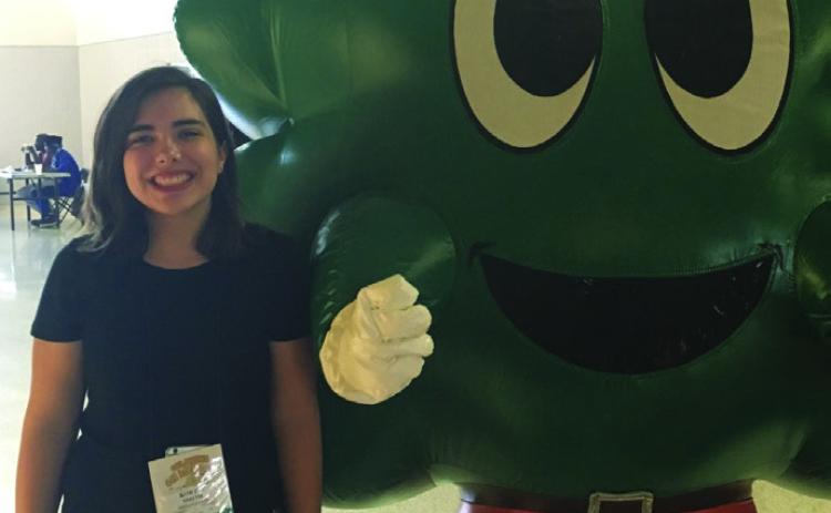 McLoud 2018 graduate Kortni Perkins poses with the 4-H mascot during the 2017 Oklahoma 4-H State Roundup. Photo provided