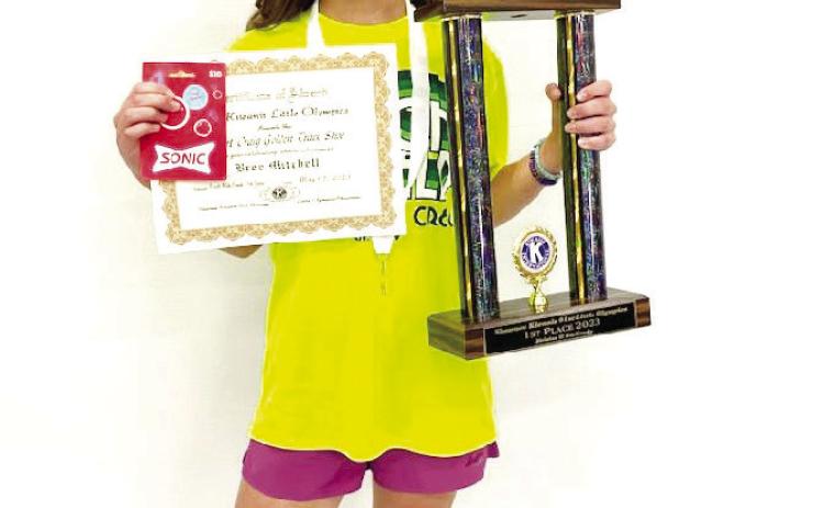 Fifth-grader Bree Mitchell, of South Rock Creek, poses with her Golden Trackshoe trophy and certificate after winning three Division II events in Kiwanis Little Olympics on May 12. Photo provided.