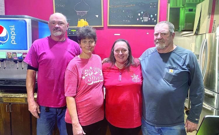 Tim and Tammy Carmichael (pictured left) stop for a photo with former owners of Cope’s Country Cafe Melissa and Pat Cope. The Carmichael’s did not want to see the business that Tammy’s family members worked so hard to build close its doors so Tammy decided to embrace the opportunity and continue the family business. Countywide & Sun/Julie Talton