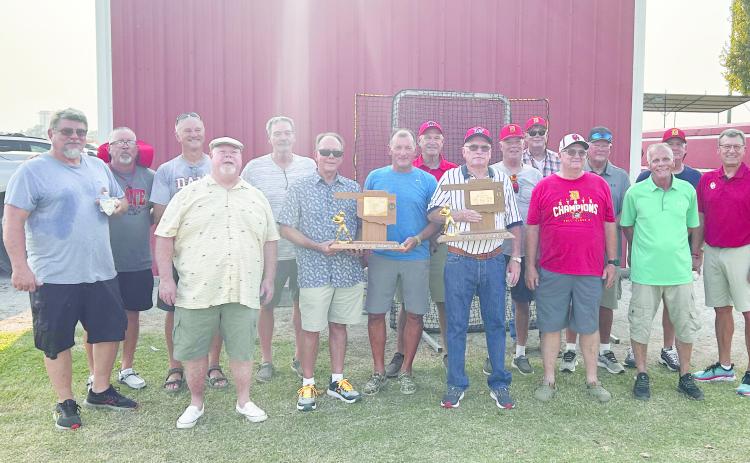 Coach Washburn is pictured with the trophies and members of the 1975 and 1979 State Championship teams and maybe a younger player or two. Countywide & Sun/Suzie Campbell