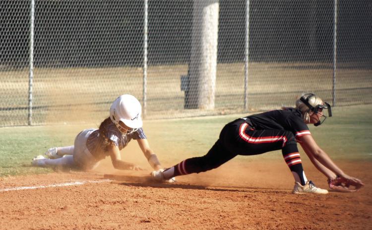 Asher sophomore Amaya McFerran holds onto the base after stealing third, as her Carney counterpart comes up empty for the catch in the first inning of the Aug. 20 home game. McFerran stole home shortly after this. The Lady Indians won 12-2, and have a record of 5-1 so far. They are hosting a fast pitch tournament today (Aug. 27) through Saturday.