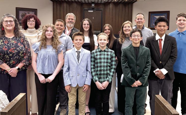 Mayor Eric Stephens passed out challenge coins to the middle school representatives of Shawnee who will be traveling to Nikaho, Japan for the Sister Cities Program. See full cutline after the story.