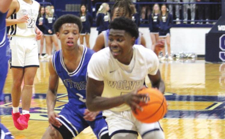 Shawnee’s T.J. Bishop drives to the basket during the second quarter of the home game against Guthrie. Countywide &amp; Sun/Natasha Dunagan