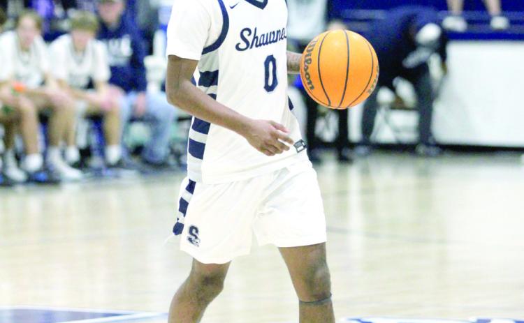 Shawnee senior Daytain Patton looks to pass in the Feb. 8 home game. Patton was also recognized before the boys game for reaching 1,000 career points and given a framed picture and the game ball from the Feb. 4 Guthrie away game. Countywide &amp; Sun/Natasha Dunagan