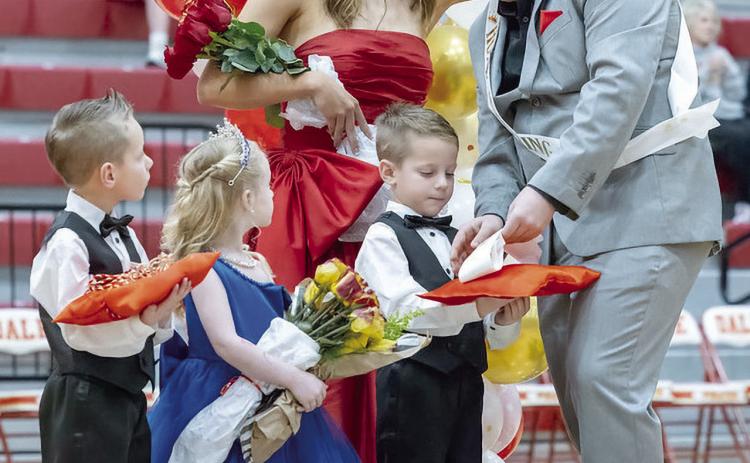 Dale Homecoming Queen Grace Anderson fixes the jacket collar of King Elijah Millette while he removes her sash from the pillow. Also pictured are twin boys Legend and Nolan Radford and carrying the flowers is Eastyn Cantrell. Photo courtesy of Richelle Treece