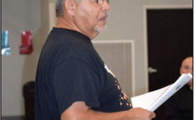 Victor Cope passes out a publication titled “Civil Rights and the Impact of Native American Names, Symbols and Imagery in School Mascots.” Countywide &amp; Sun/Julie Talton