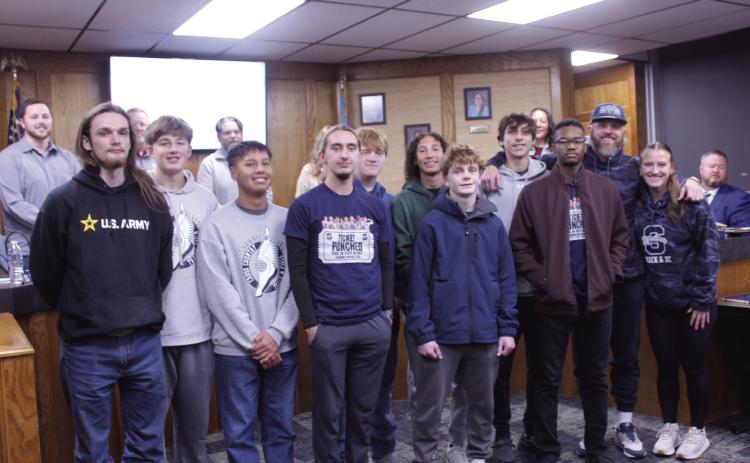 The Shawnee High School Cross Country team was recognized for competing at the state competition, during the Dec. 15 Shawnee Board of Education meeting. From left, they are Ayden Ringwald, Jack Timmons, Kain Nenaikita, Conner Brantley, Colby Jones, Joseph Bevel, Booker Dahlman, Emersen Byers, Izayiah New, Coach Bobby Licklider. and Coach Jaylin Stapleton. Natasha Dunagan, Countywide & Sun
