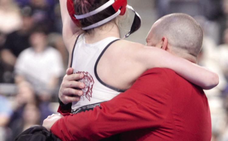 McLoud's Remy Whitney jumps into her dad's/coach's arms after winning her State Final match on Feb. 28. Her father, Coach Chad Whitney, was also named Class 5A Girls Coach of the Year, making them the fourth father-daughter duo in state history to both win individual state titles, according to Oklahoma Wrestling.