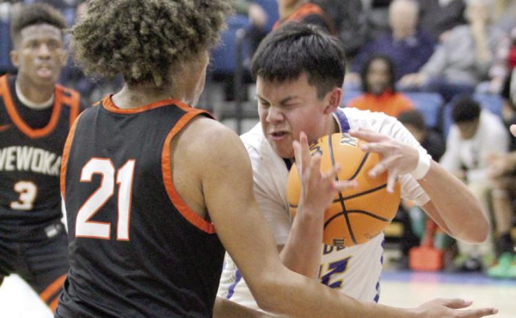 Bethel sophomore Ryder Davenport guards the ball as he makes his way to the hoop during the Jan. 30 home game with Wewoka. The Wildcats lost a hard-fought game, ending at 53-56 in overtime. Countywide & Sun/Natasha Dunagan