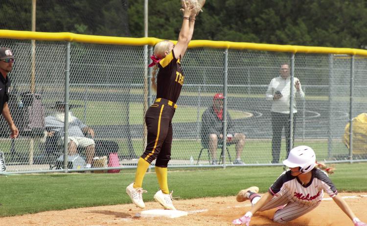 Tecumseh senior Blakelee Parker reaches high for the catch, as McLoud junior Ella Smith slides into third base, during the April 29 Class 5A Slow Pitch Regional Tournament game at Tecumseh. The Lady Savages won that game, 4-3, and the earlier game with Guthrie, 8-3, to become Regional Champions. Photos by Natasha Dunagan, Countywide &amp; Sun