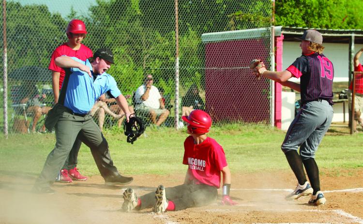 Macomb senior Connor Hutchinson slides in to steal home but is declared out by the umpire after Earlsboro senior, pitcher Jon Wilkins (#19), ran up for the tag during the baseball game at Macomb on Aug. 14. The Earlsboro Wildcats won, 18-0.