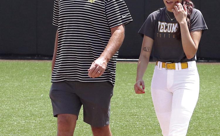 Tecumseh 2024 graduate Serenity Jacoway and Fast Pitch Coach Chad Trahan walk onto the field at the All-State Game held Saturday, June. 8. Photos by Kent Bush.