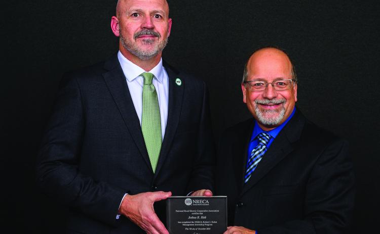Pictured above is (left) Josh Holt with Gary Pfann, Director, Executive and Staff Education, National Rural Electric Cooperative Association. Photo provided
