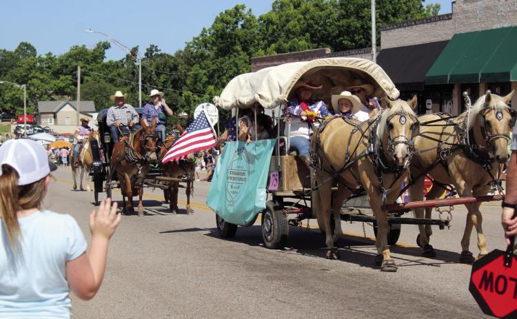 A covered wagon and carriage from Crossroads Cowboy Church in Harrah make their way east on Broadway Ave. during the McLoud Blackberry Festival Parade on June 21, 2025. File photo