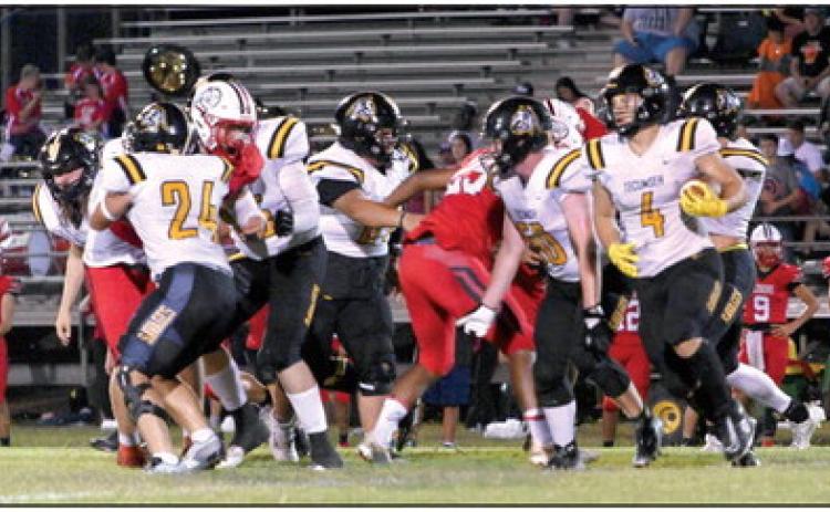Tecumseh senior Ross Griggs (#4) breaks away from the pack to run the ball in the away game at McLoud on Sept. 15. The Savages won, 26-13. Photo provided by Kenetta Lisenbee.
