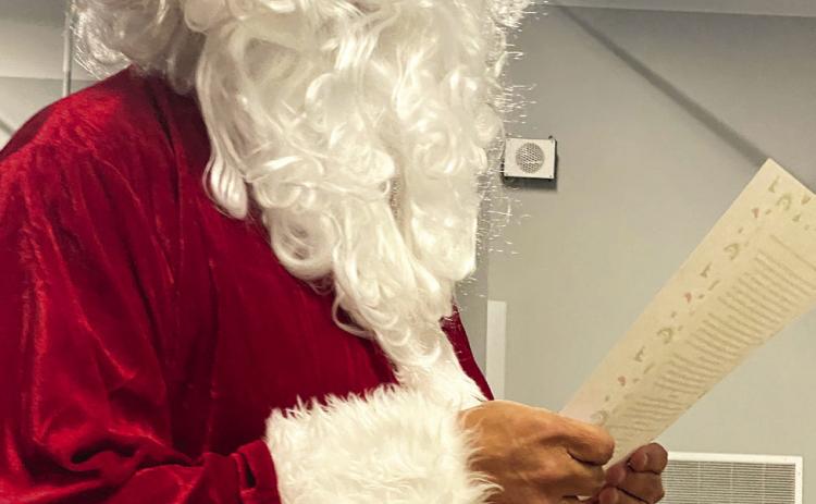 Victor Cope, dressed as Santa Claus this month, made his continuing plea the board to remove the “Savage” name. This month, he read about a dark chapter at Christmastime. Countywide &amp; Sun/Julie Talton
