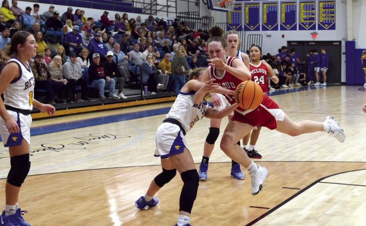 Creighton Conley tries to pass the ball as Brooklyn Duff pushes it away during the matchup between McLoud and Bethel on Feb. 2nd. The Lady Redskins lost 35-55.