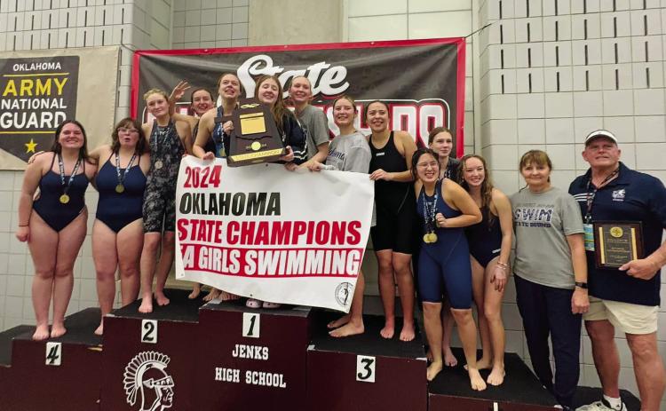 Despite the many hurdles created by the April 2023 tornado, the Shawnee Girls Swim team pushed their way to a third straight State Championship. The team posed for a quick photo with the newest banner. Photo provided