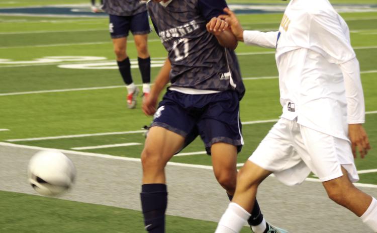 Shawnee's Derek Lopez (#17) jockeys for possession of the ball at the April 17 home game against Will Rogers. The Wolves won 4-3. Photos by Natasha Dunagan, Countywide & Sun