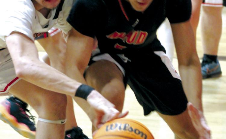 Maud junior Curtis Jordan tries to keep control of the ball as Macomb sophomore Radlee Blaine tries to steal it at the Macomb home game on Nov. 28. Maud won, 60-36.