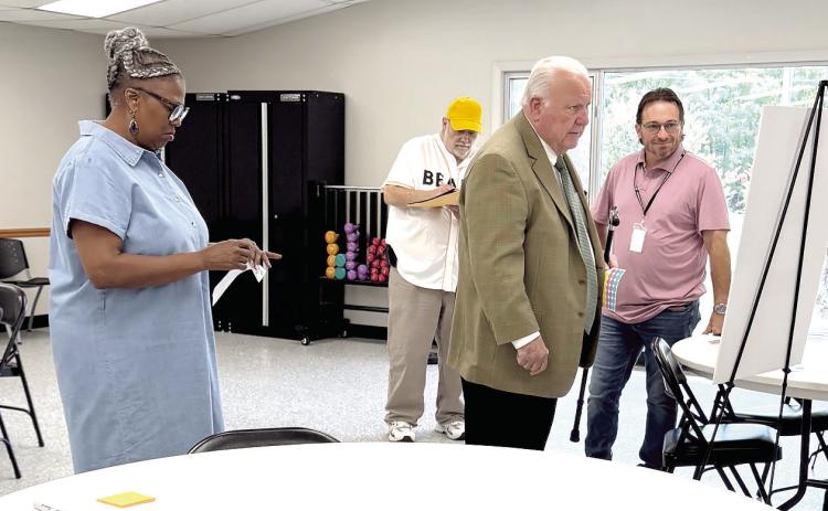 Darlene Richardson (far left) and Rocky Barrett give their opinion on what they prefer to see at Farrall Park, while Butch Lutomski and Ward 3 Commissioner Chris Odneal look on, at the morning session of the Farrall Park Vision meeting held on Aug. 6. Another meeting was held that evening at 7 pm.